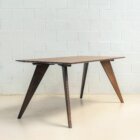 Photograph of Saarinen dining table in dark stained finish.