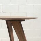 Detail photo of Saarinen dining table in dark stained finish.